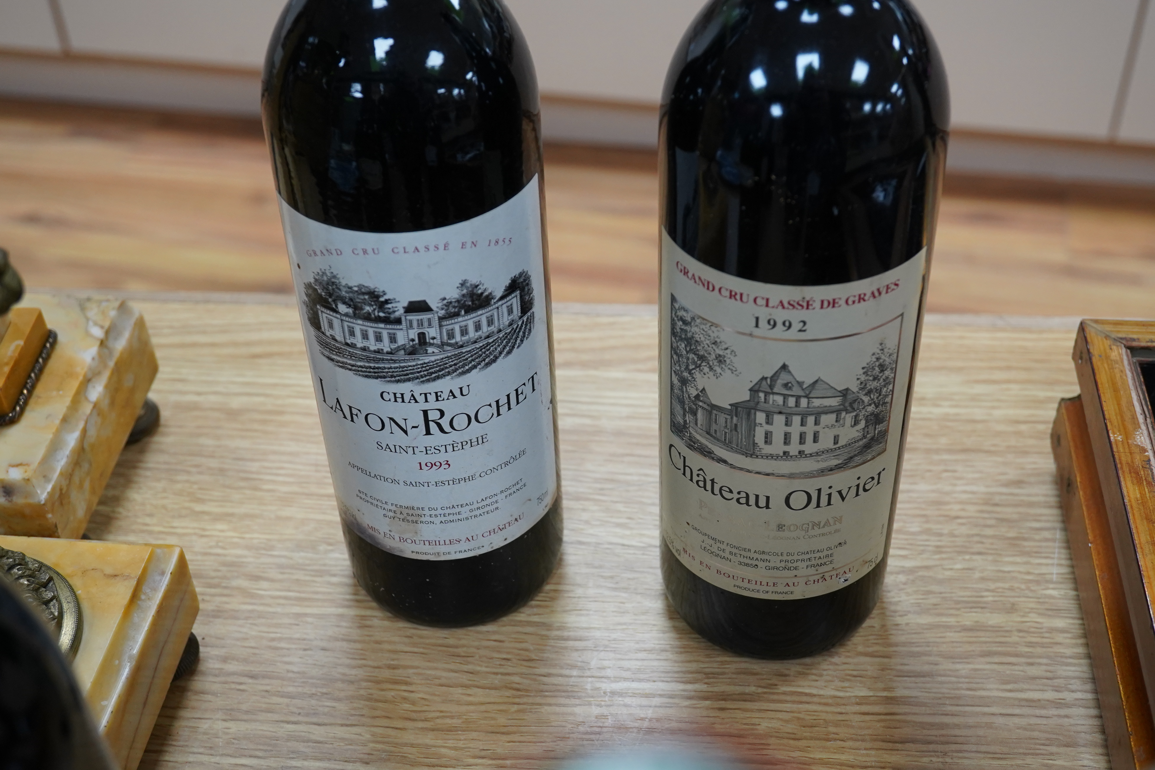 Six mixed bottles of French red wine: a bottle of 1992 grand cru classe de graves, Chateau Olivier, a bottle of 1993 grande classe Chateau Lafon- Rochet, Saint-Estephe, a bottle of 1988 grand cru classe, Dauzac, Margaux,